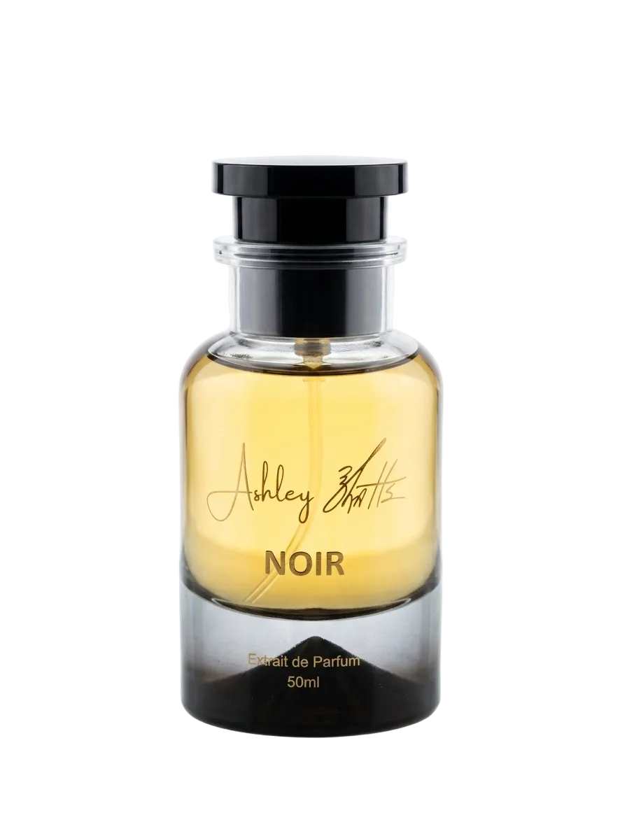 Perfume bottle labeled 'Noir' by Ashley Watts on a white background